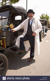 driver-in-driving-clothes-posing-in-front-of-antique-car-in-santa-BGGYA8.jpg